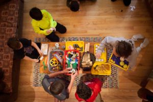 Kids playing with Rube Goldberg objects