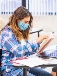 High School student, reading a book and taking notes, at The Sycamore School in Arlington, Virginia.