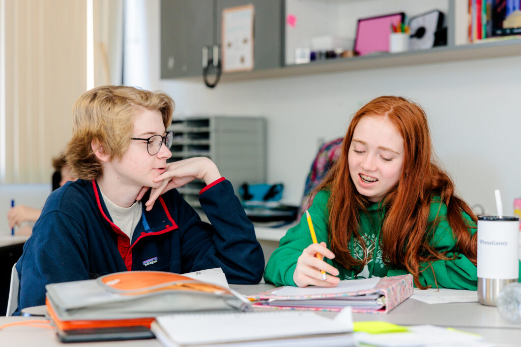 Middle School Boy and Girl Collaborating at School