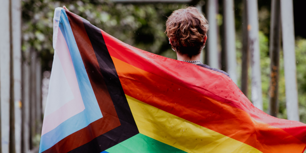 Person with LGBTQ+ flag