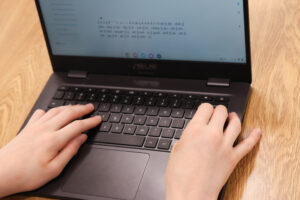Student typing on computer in a foreign language