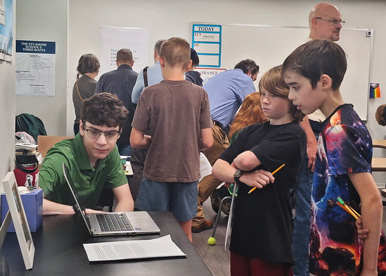 The Sycamore School students looking at a laptop in class