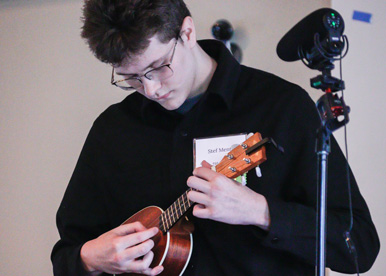 The Sycamore School student playing ukelele on stage