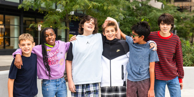 Home-Hero-Mobile Middle School students at The Sycamore School with their arms around each other and smiling